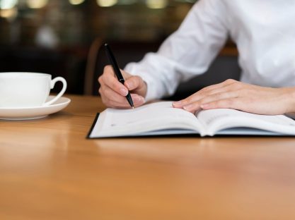 employee-writing-agenda-front-view_23-2148377742